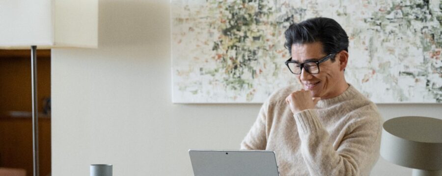 a person sitting in front of a laptop computer