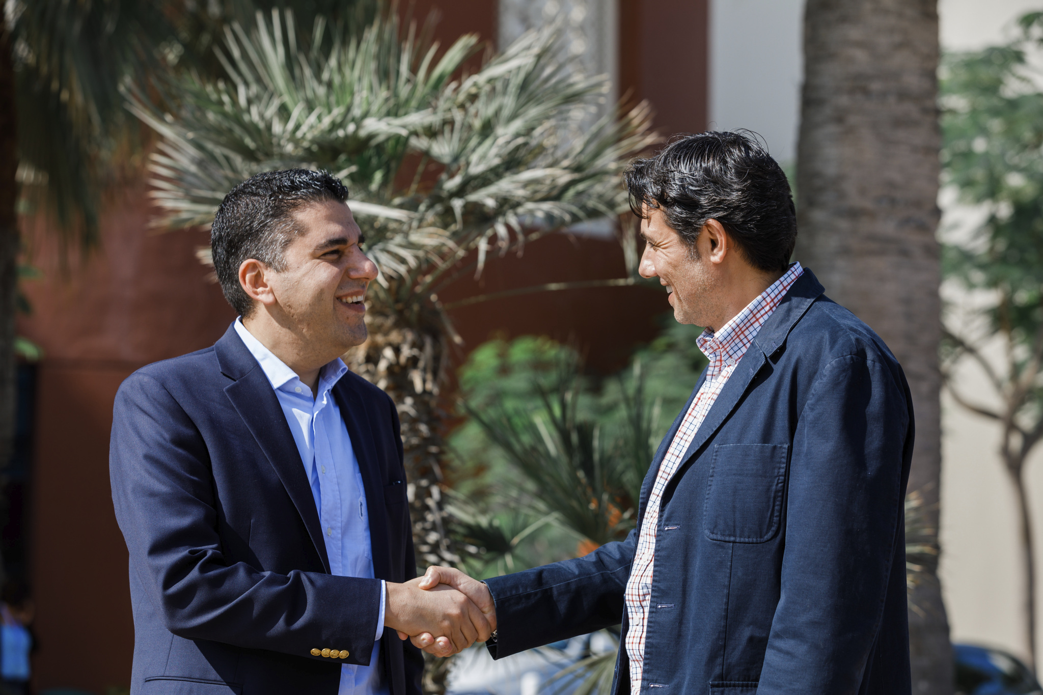 Two business people shaking hands and smiling