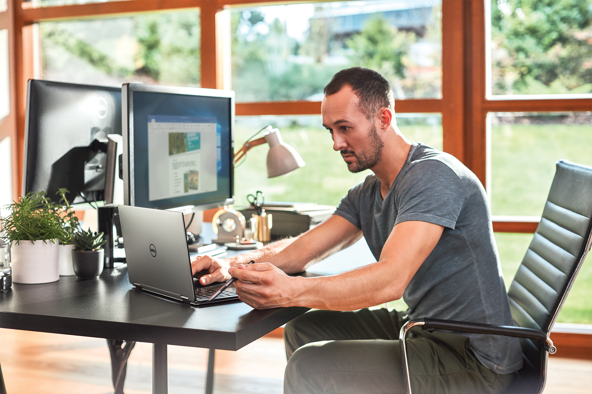 a man sitting at a table using a laptop