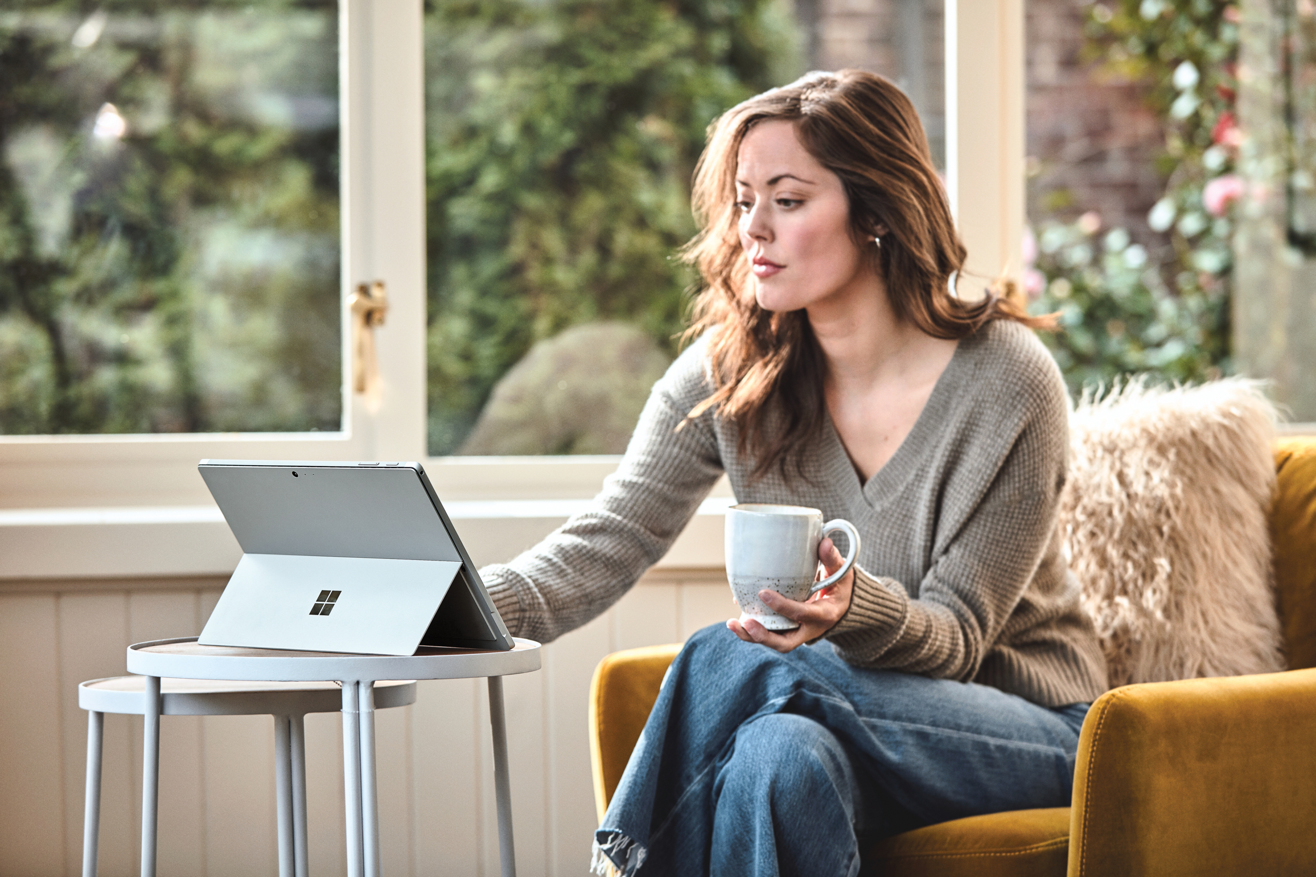 Woman interacting with a Surface Pro laptop