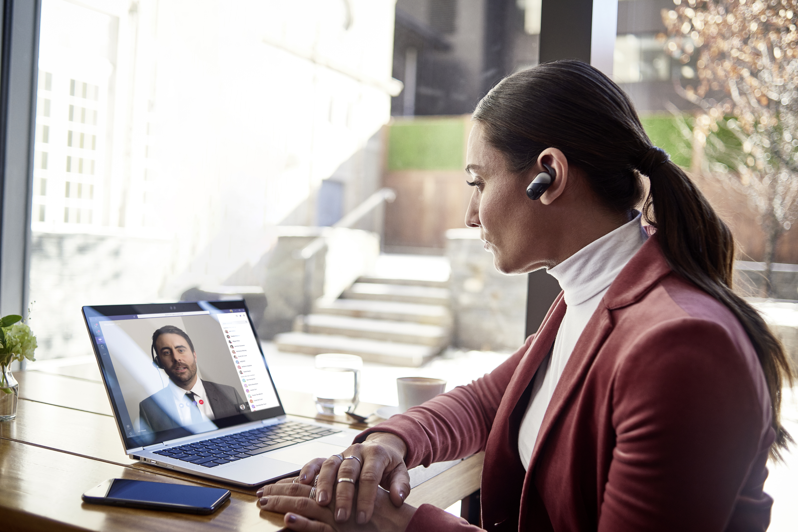 Female small business executive using HP Elite device on Microsoft Teams; bluetooth; coffee