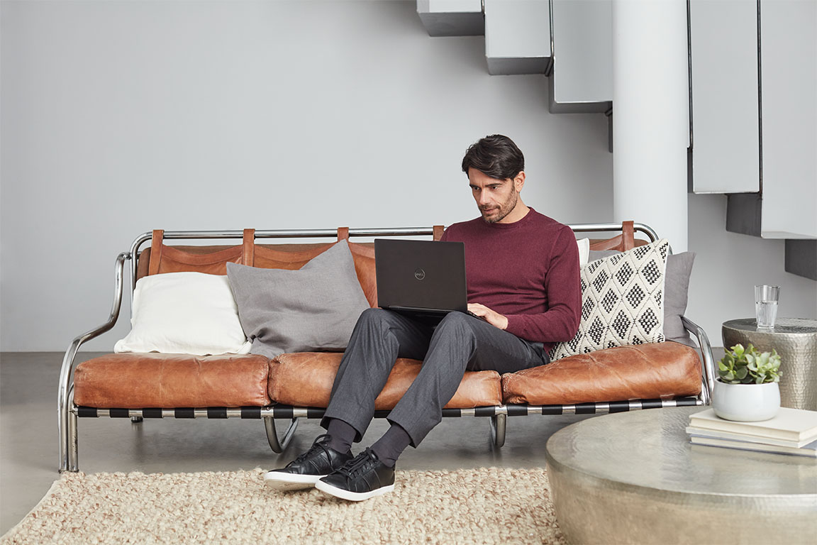 Adult inside home working on laptop. Back to school. Dell Inspiron 7000 2-in-1