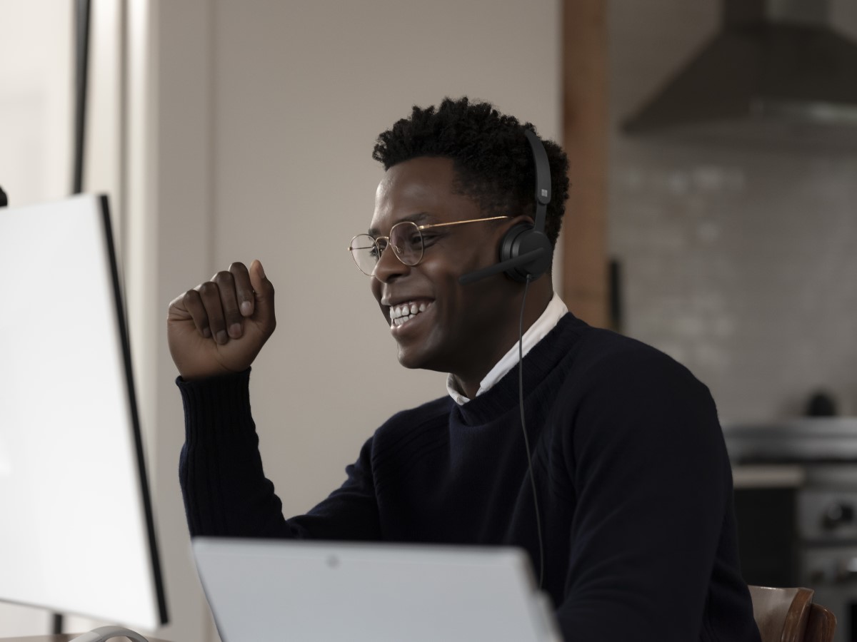 Adult male inside using Microsoft Modern USB Headset