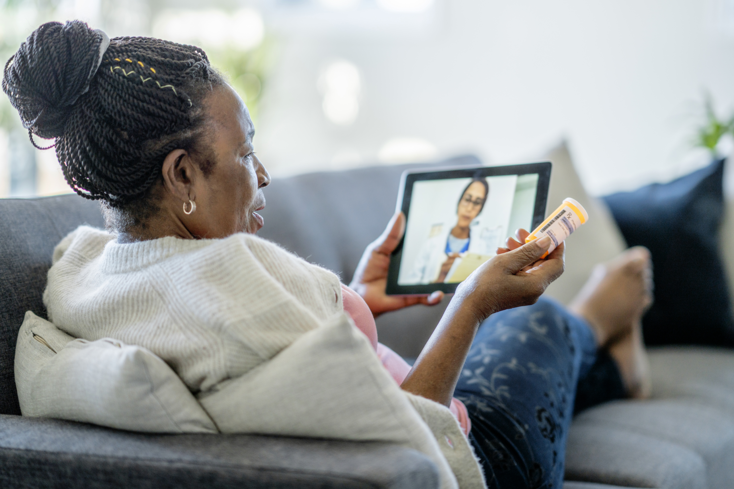 Telemedicine call between a senior woman and her doctor.