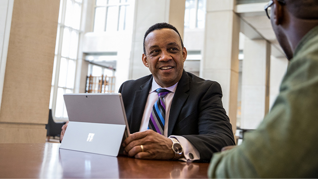 Banker using his Surface Pro with a client