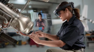 Woman using Microsoft Dynamics 365 Remote Assist in a manufacturing setting
