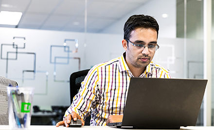 Image of a man at work in front of a laptop