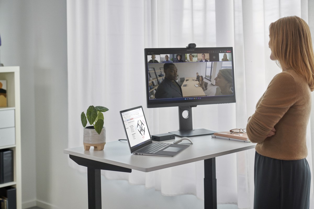 Surface Hub remote participant standing at a desk showing the Hub 2 Smart Camera perspective