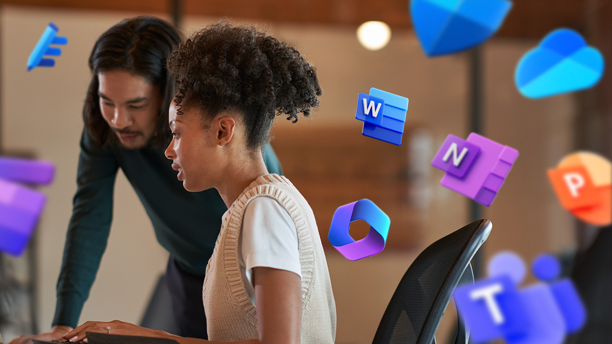 Two coworkers looking at a computer together. Icons of Microsoft 365 products surround the people on the image