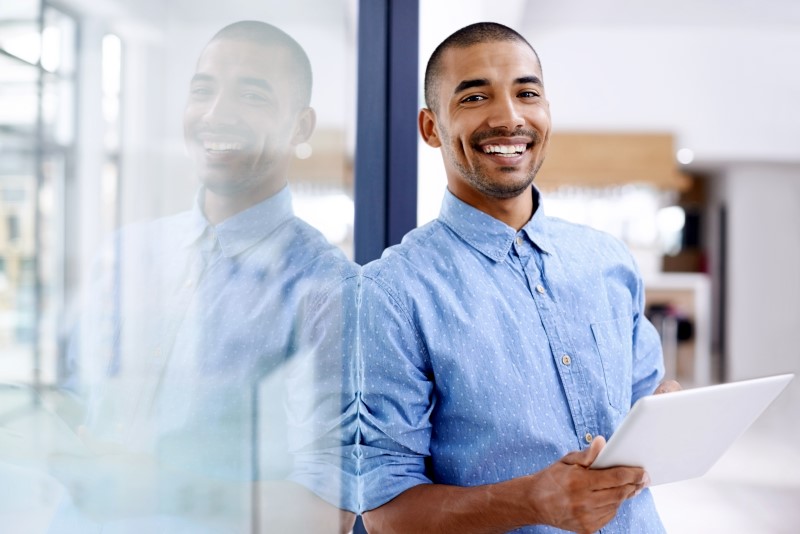 Shot of a young entrepreneur using a digital tablet in a modern office