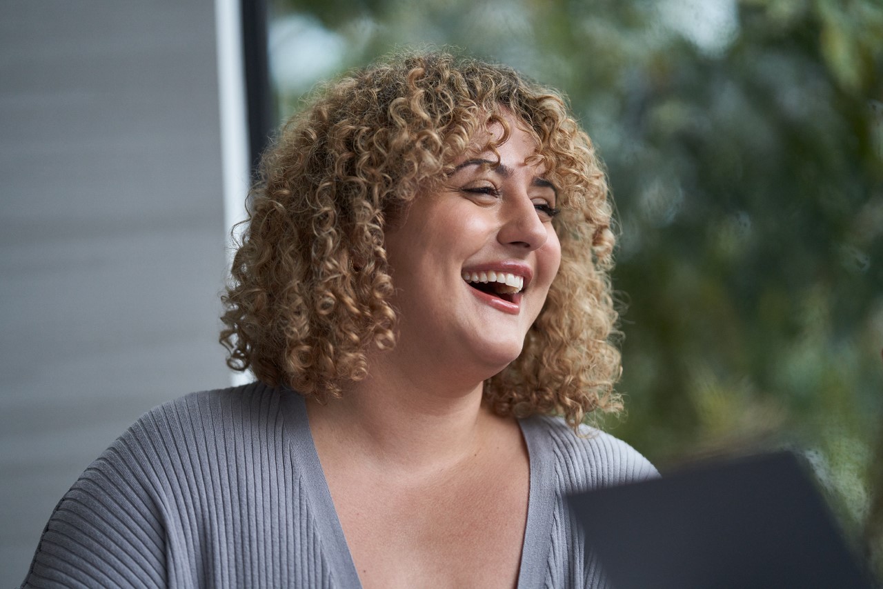 Close-up of woman looking to the side, smiling