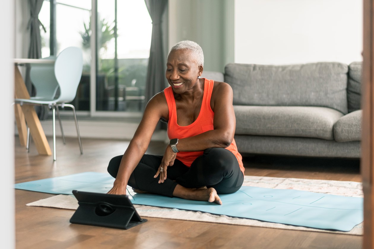 A woman taking a break from work and practicing yoga in her living room