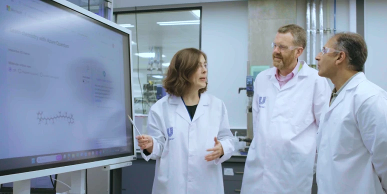 A group of scientists working together on breakthroughs powered by AI
