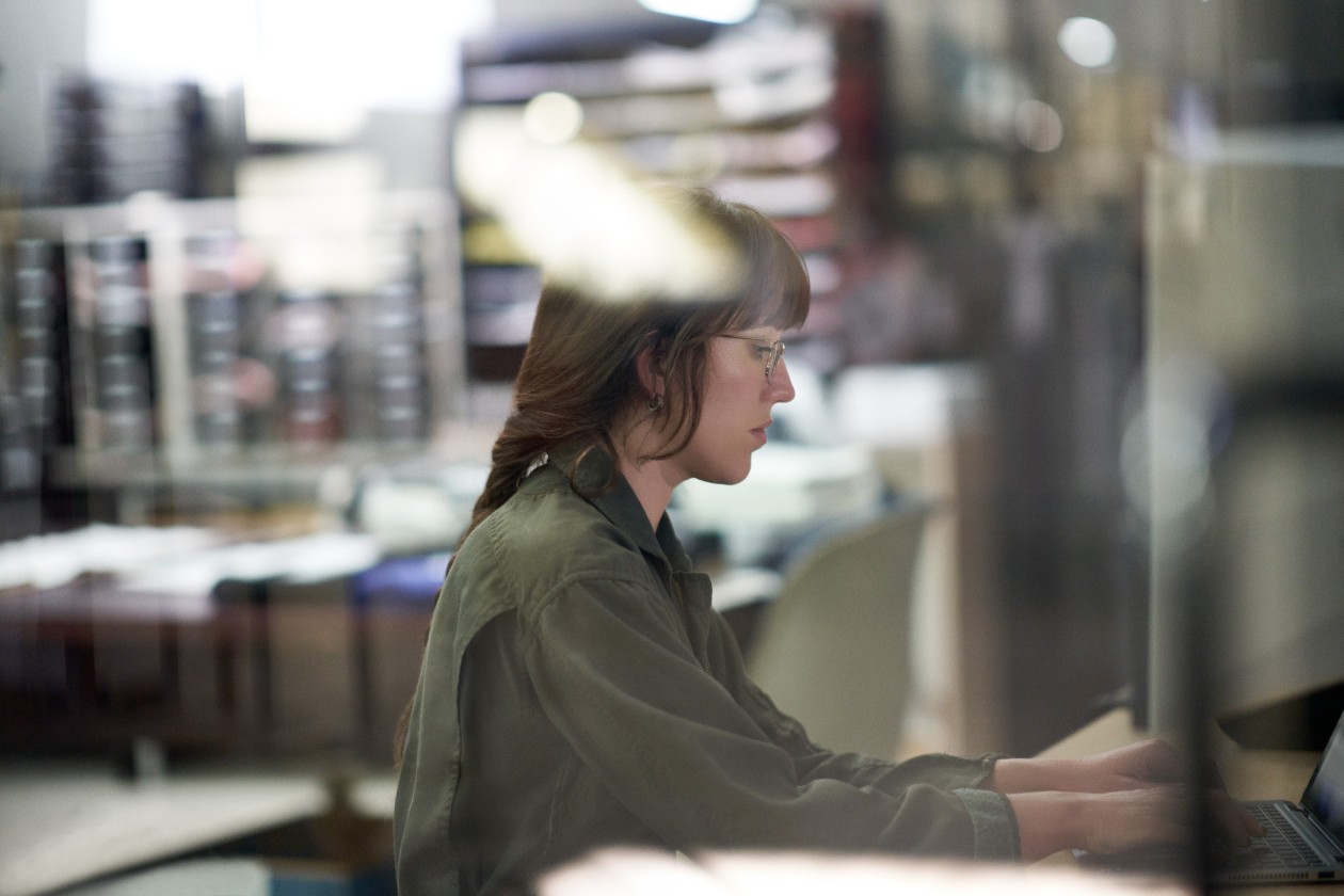 Decision maker creating a survey or taking a security assessment on the warehouse floor of a textile manufacturing plant