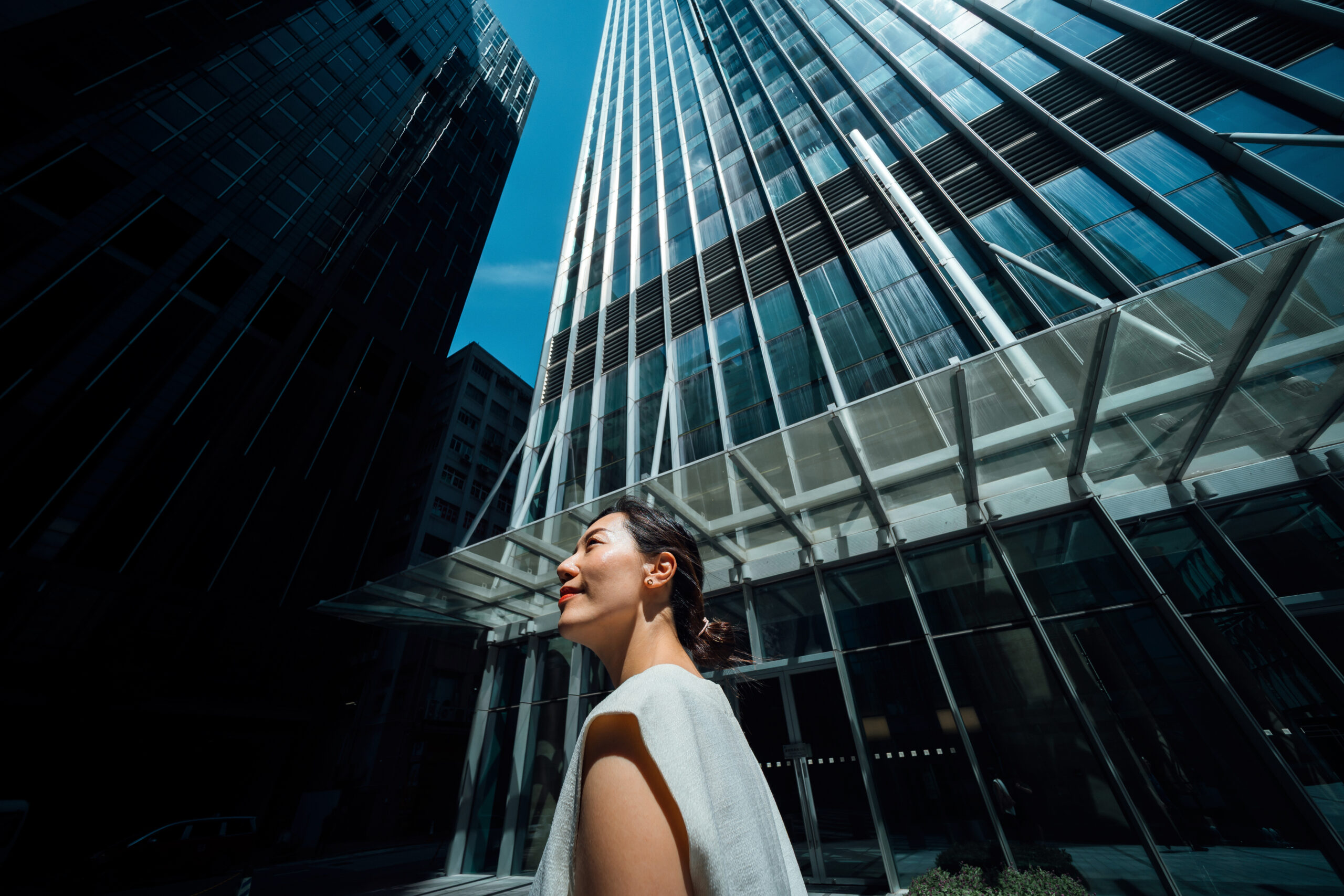 Woman walking near tall buildings