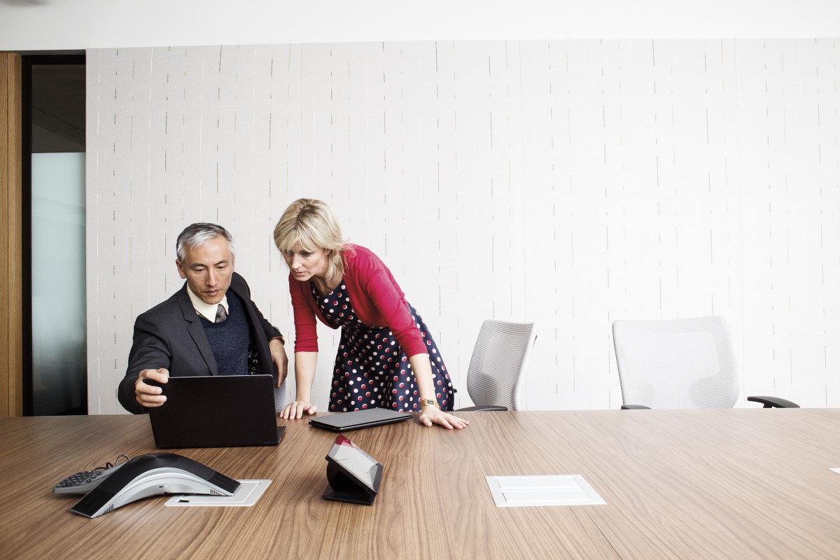 Business man and woman in meeting with laptop