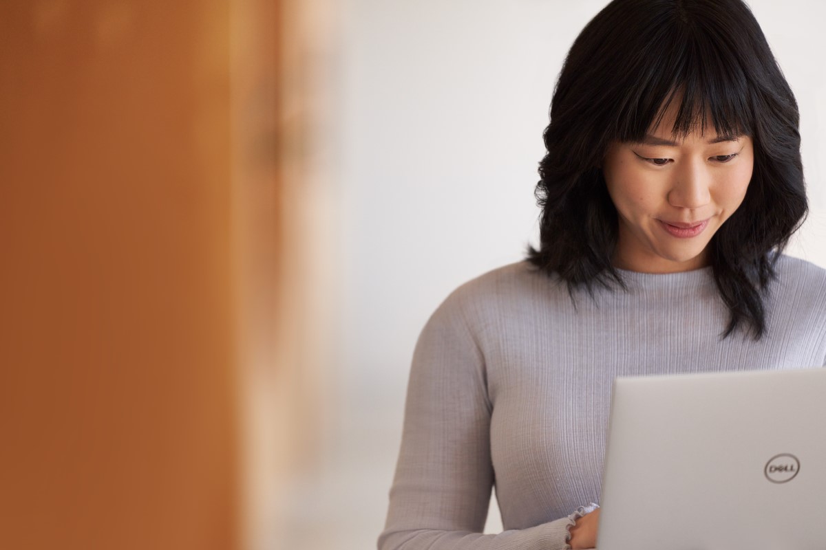 A woman engaged in focus on a laptop