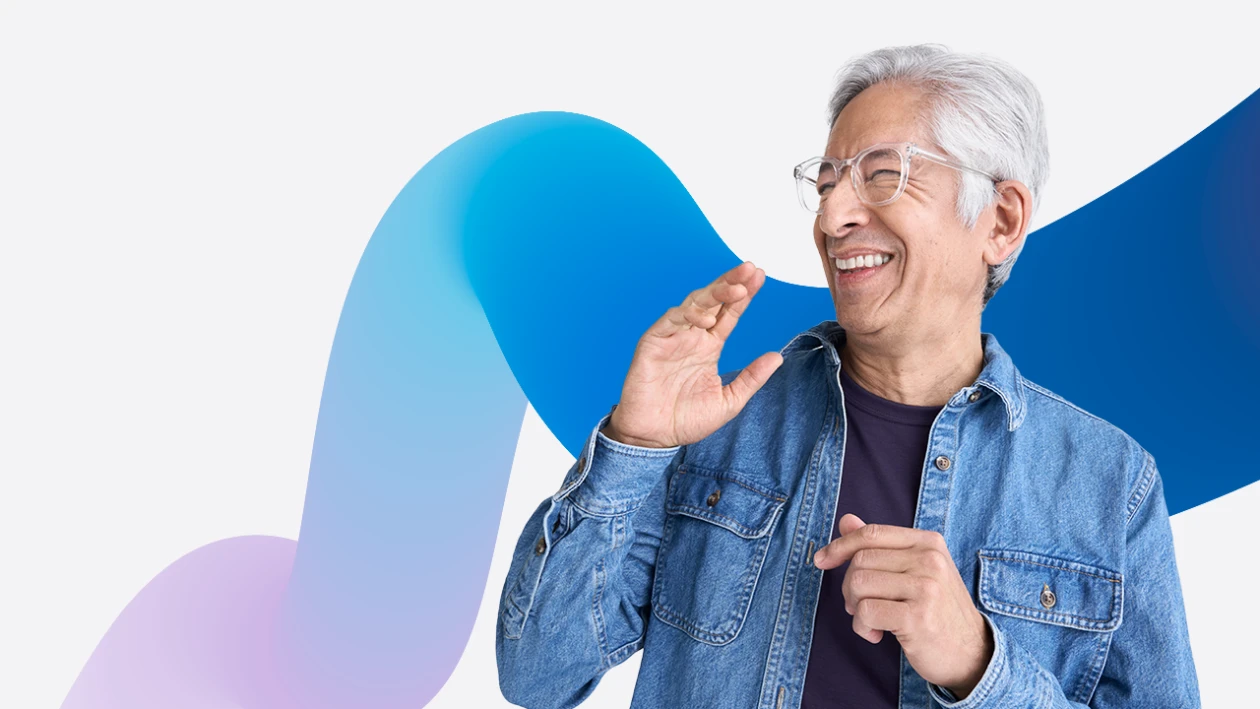A person in a denim jacket and glasses looking to the side laughing. The image is overlaid on a purple and blue gradient squiggle graphic