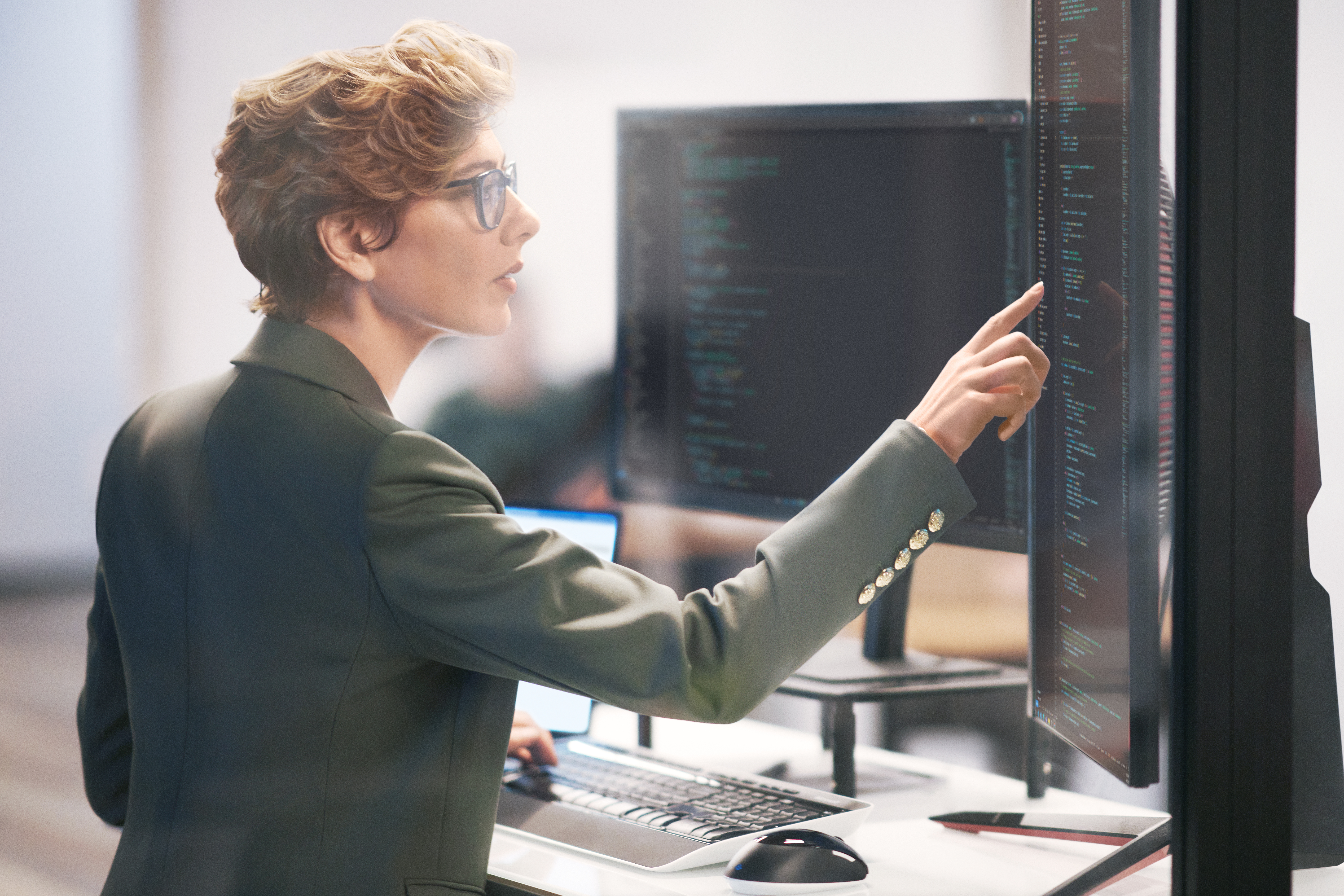 A woman pointing at a computer screen