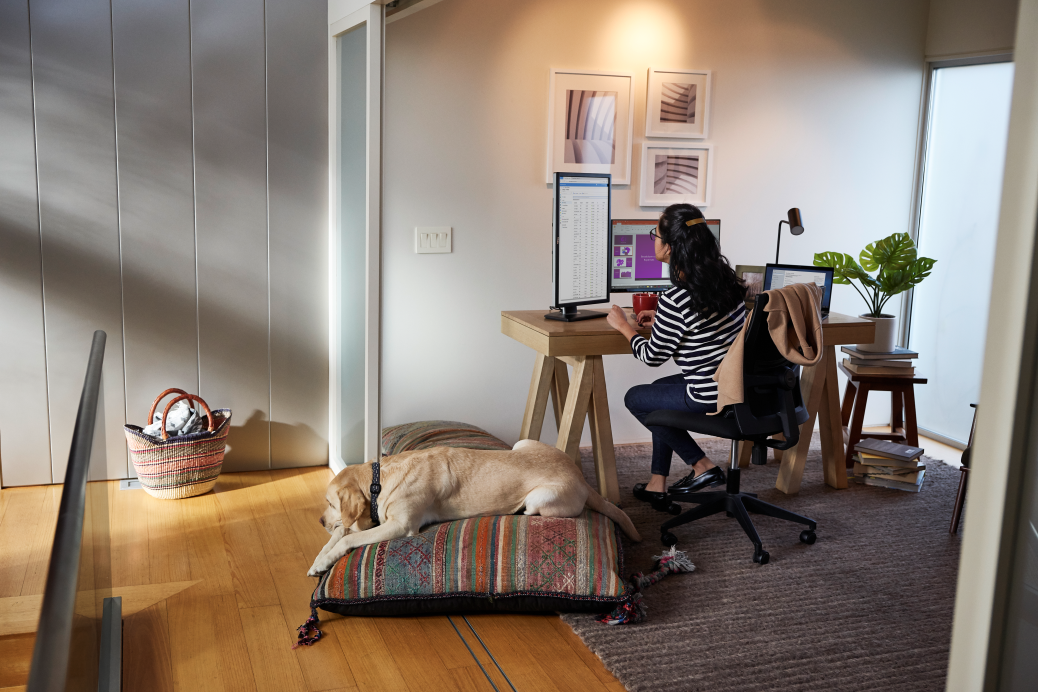 Female working remotely from her home office on a Dell Latitude device