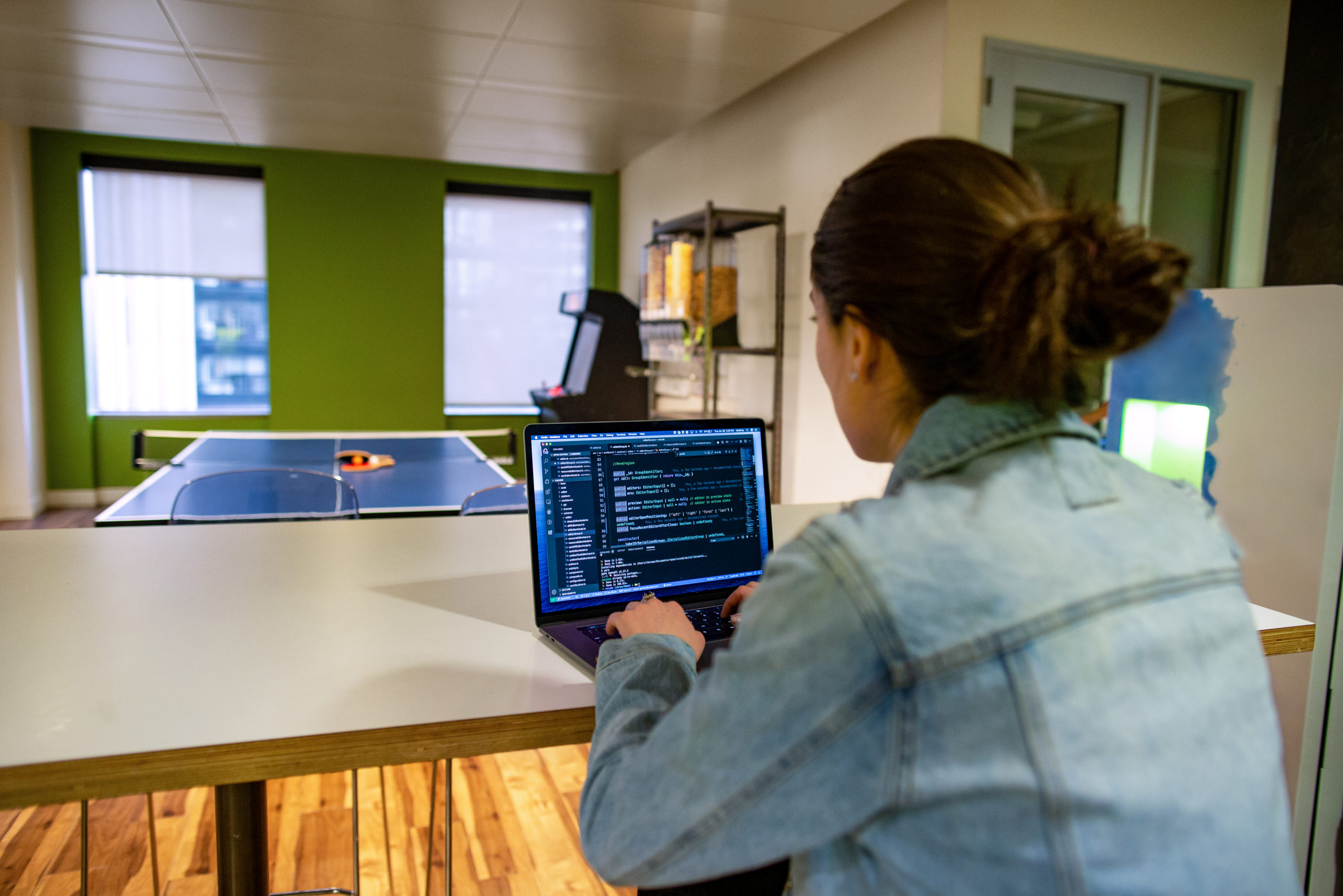 Female developer working on the go from the office breakroom or kitchen