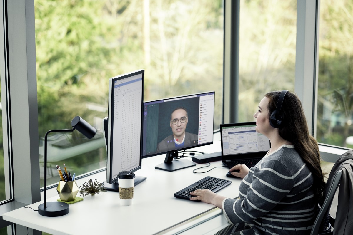 Female enterprise employee working remotely from home on a Lenovo device, running Microsoft Teams