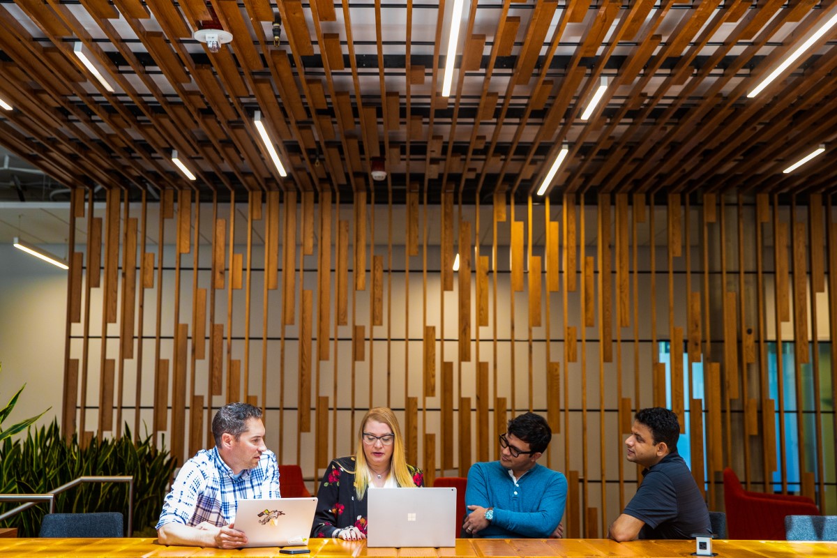 A group of tech workers hold meeting in common space of U.S. office