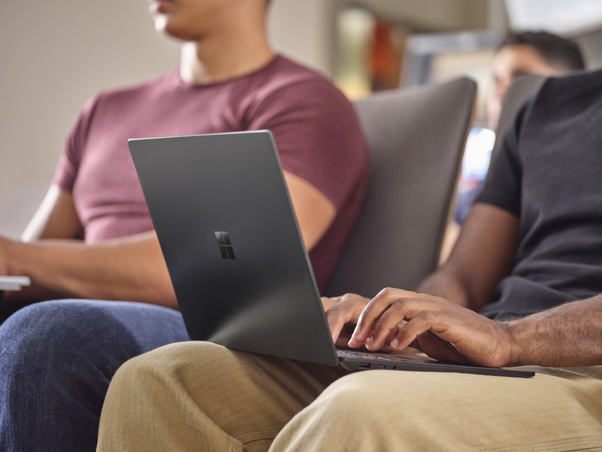 Adult male typing on laptop in lap