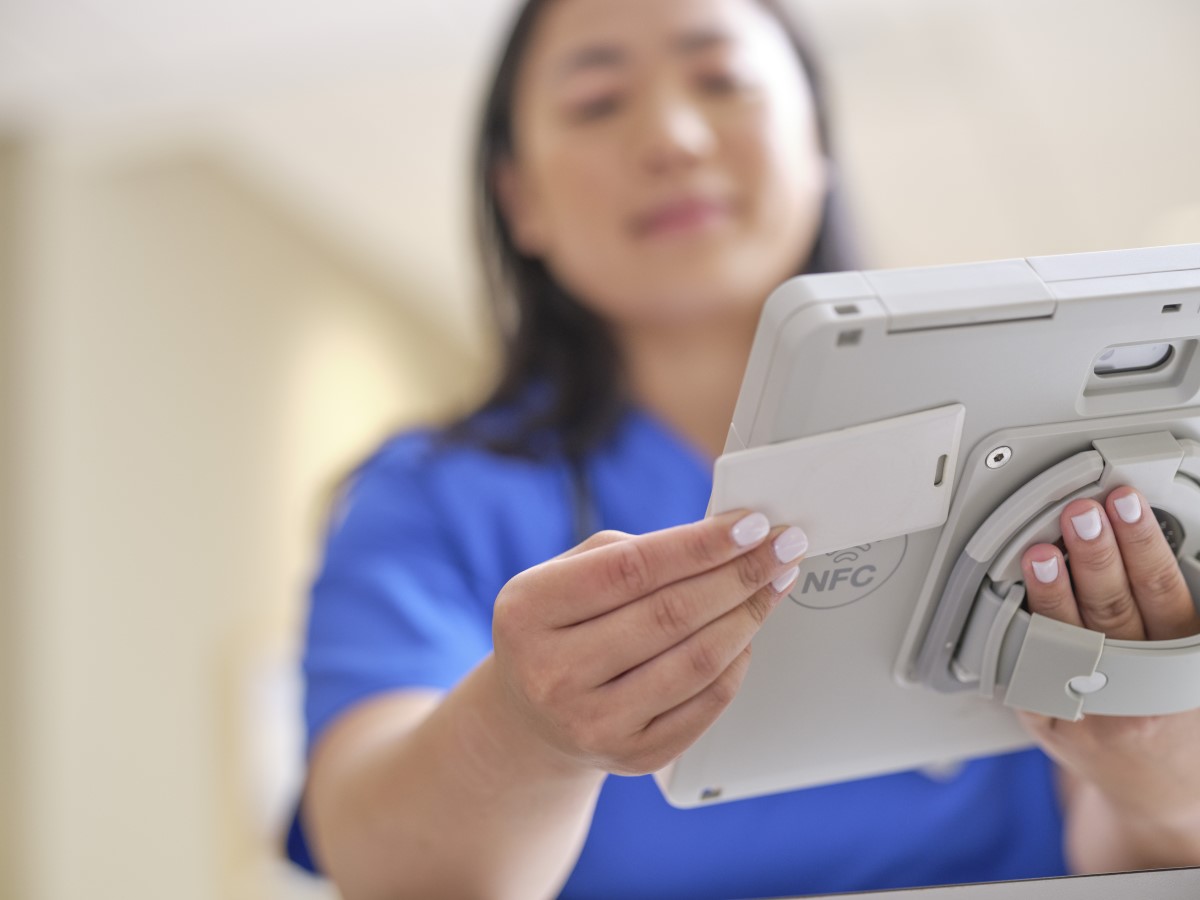 A nurse is holding Surface Go 3 in a ruggedized case