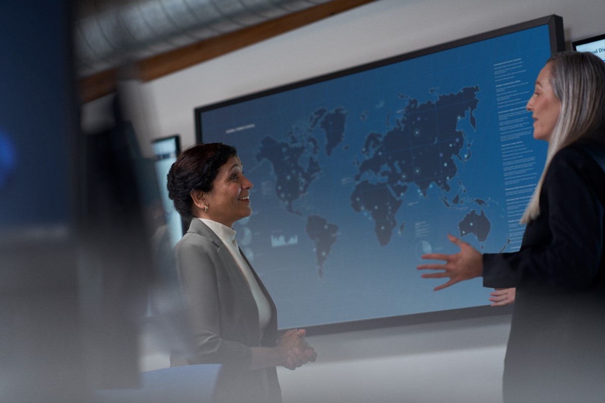 Chief information security officer collaborating with a practitioner in a security operations center