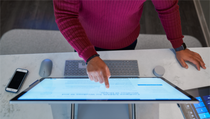 A man pointing at a computer screen