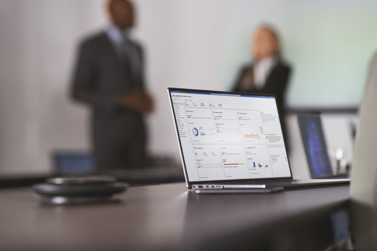 Camera focused on laptop screen showing security dashboard while security decision makers present to the board of executives on security topics