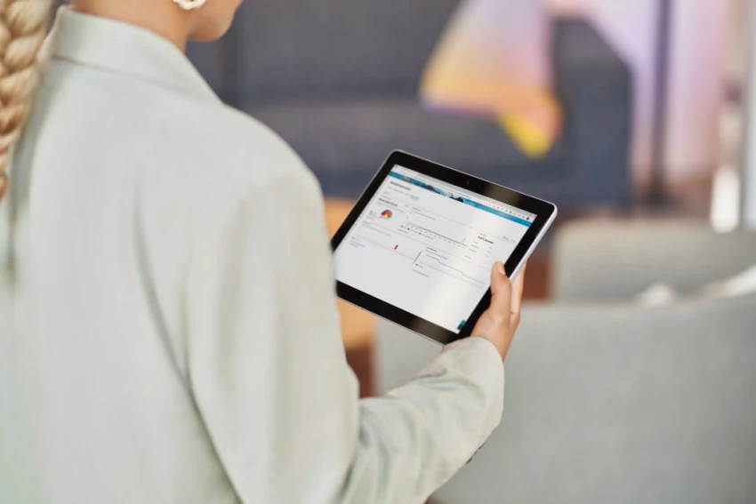 A woman looks at a tablet
