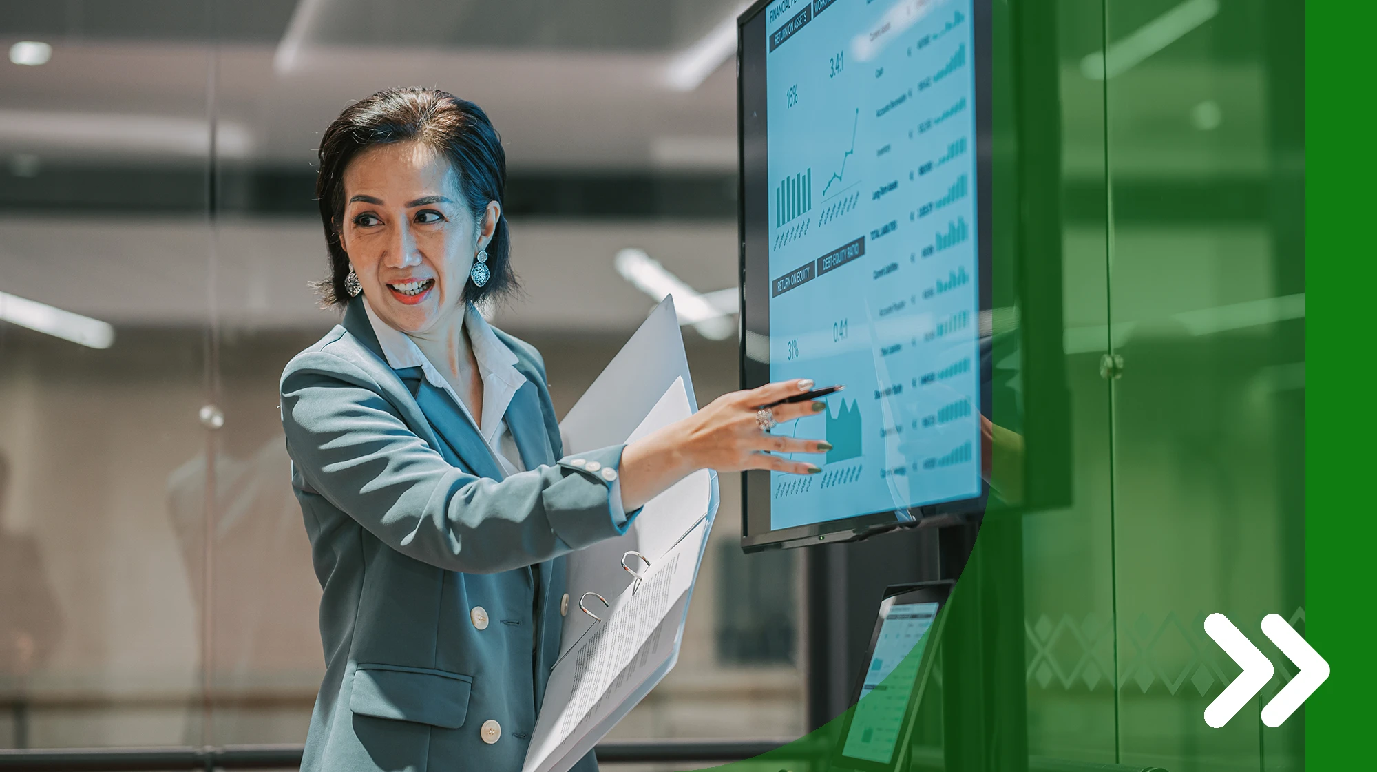 A woman points at a computer screen