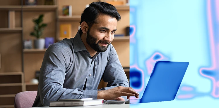 Man with smile on face working with laptop