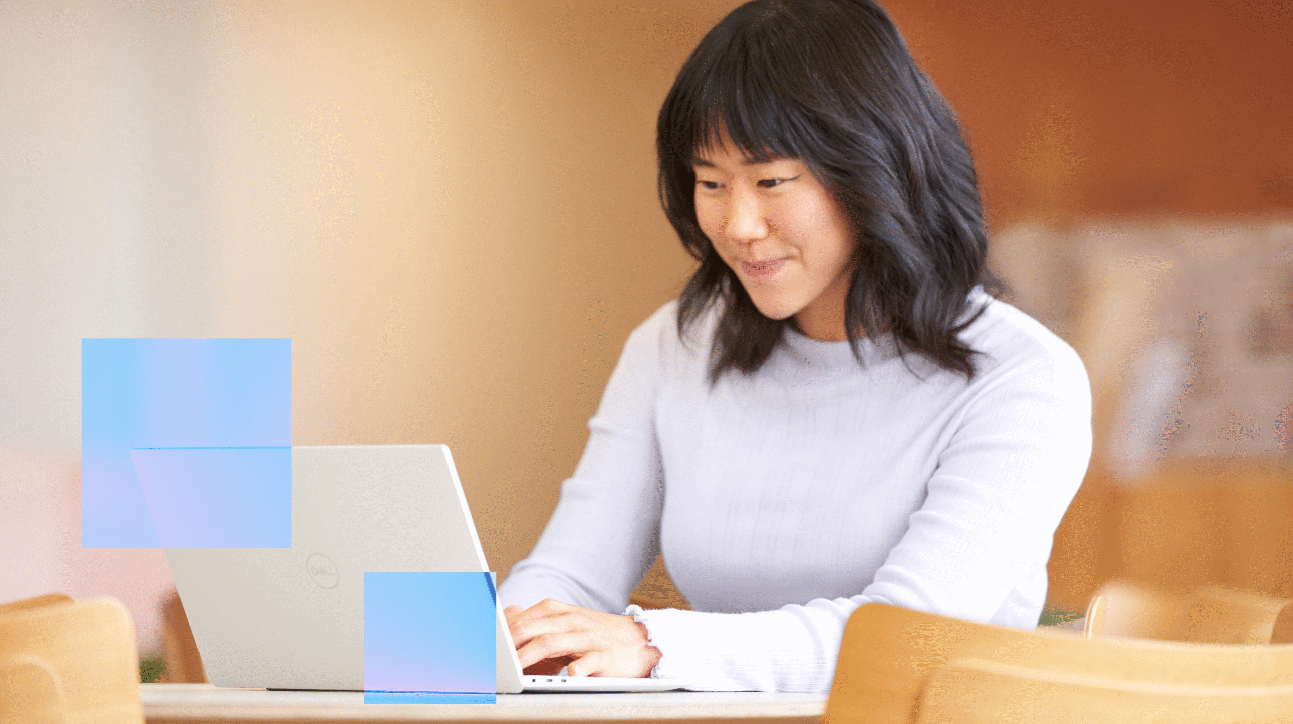 A woman types on a laptop