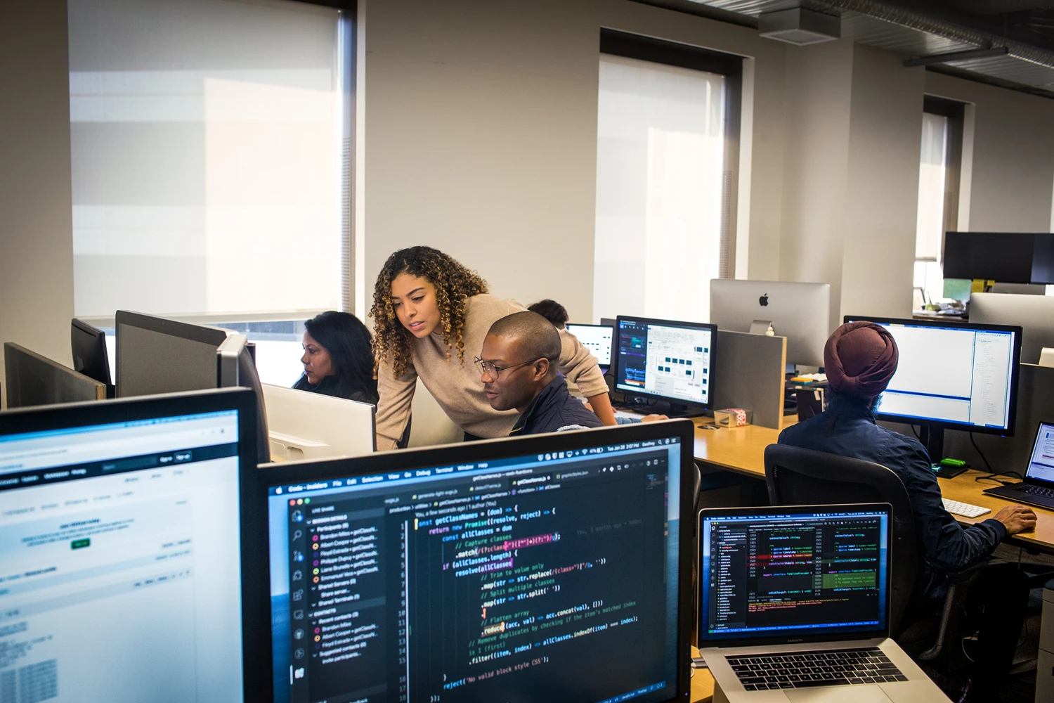A group of workers sitting at computers.