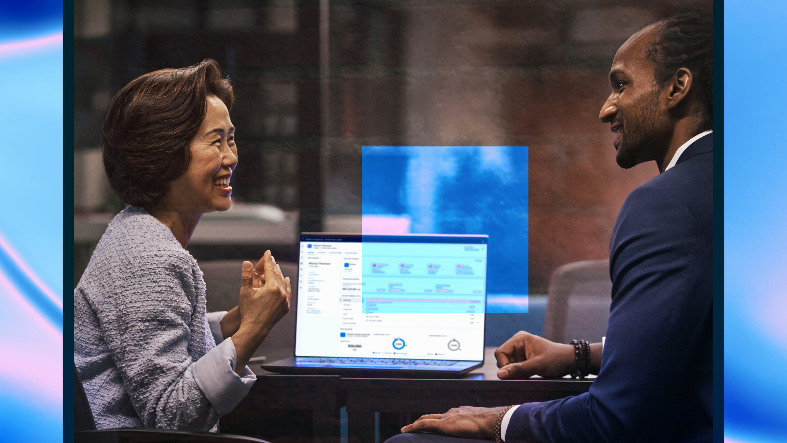 Satisfied customer working with investment advisor on investment decisions with monitor showing intelligent app powered by Azure to make intelligent, real-time decisions with customers