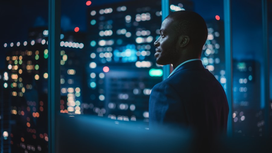 men in an office at night